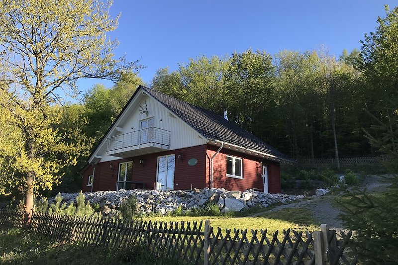 Haus mit Garten und Pflanzen im ländlichen Dorf.