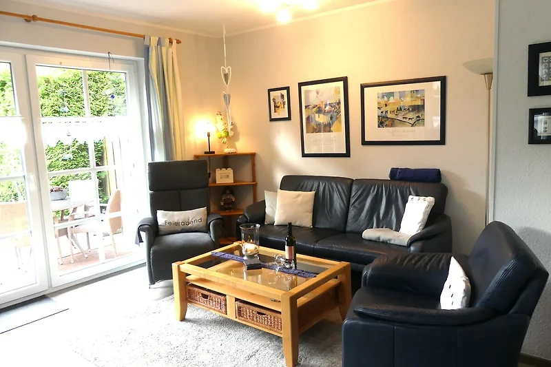 Sofa, Sessel und Couchtisch laden zum Entspannen im Apartment ein.