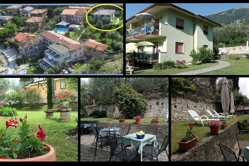 Haus mit großem Garten. Verweilmöglichkeit mit Tische, Stühle, Liegestühle und Sonnenschirme