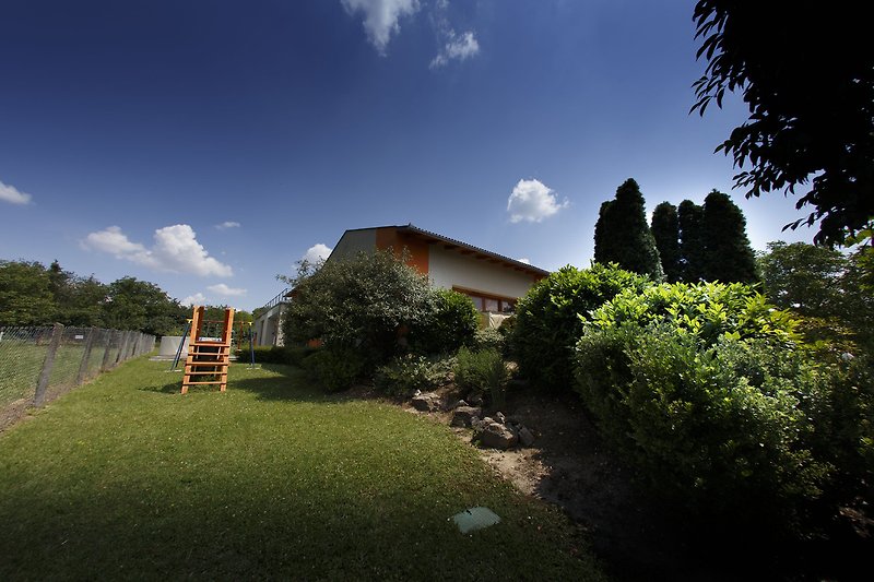 Schönes Ferienhaus mit grünem Garten und Blick auf die Natur. Perfekt zum Entspannen und Erholen.