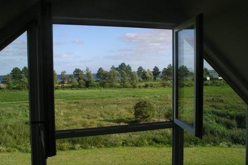 Durch das Panoramafenster kann man Wiese und Ostsee genießen