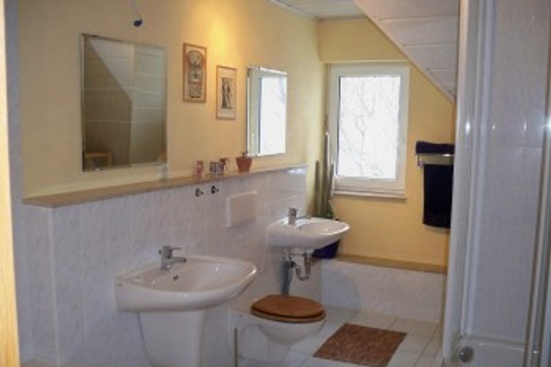 Bathroom with shower, corner bath, 2 wash basins, hair dryer, various cosmetics