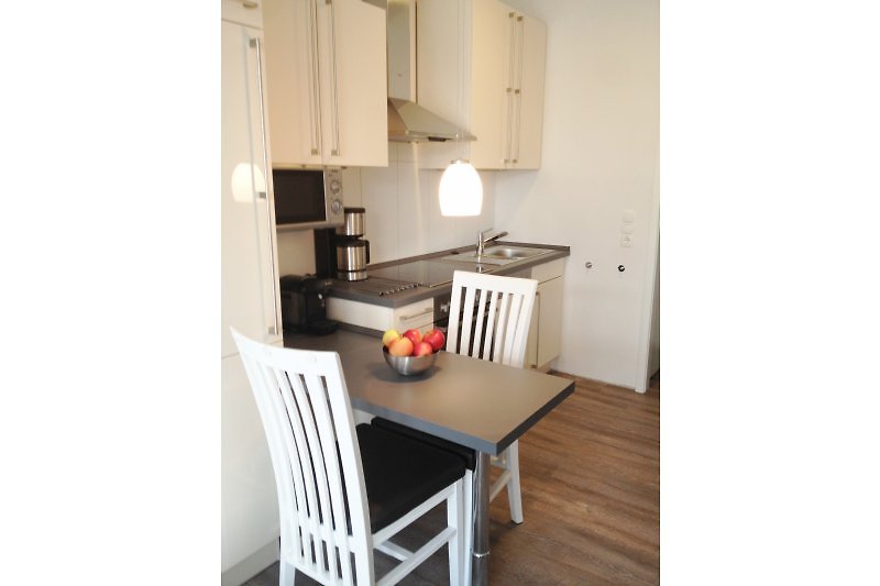 Fully equipped kitchen with corner table WOOGEHUS.