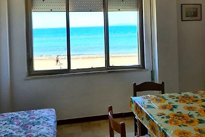 Beach flat with sea view, wooden furniture, table by the window