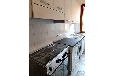 Modern kitchen with gas and electric cooker and washing machine