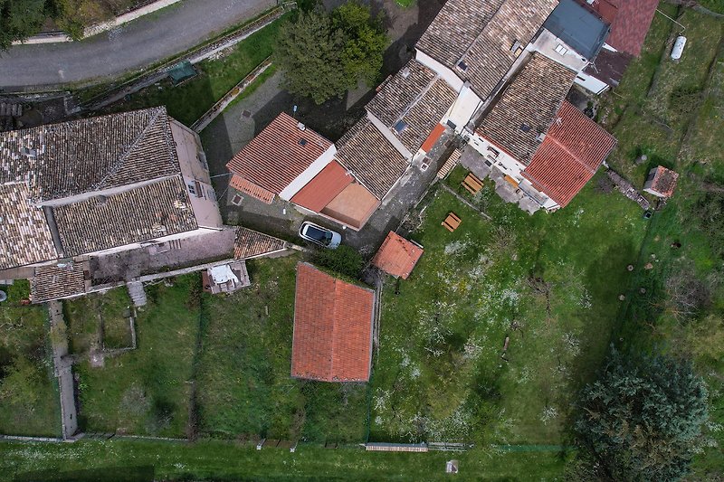 Aerial view of the house, the garden and the neighborhood