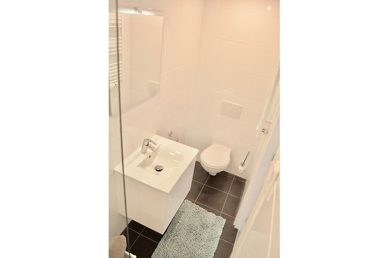 Schönes Badezimmer mit lila Fliesen und modernen Armaturen.