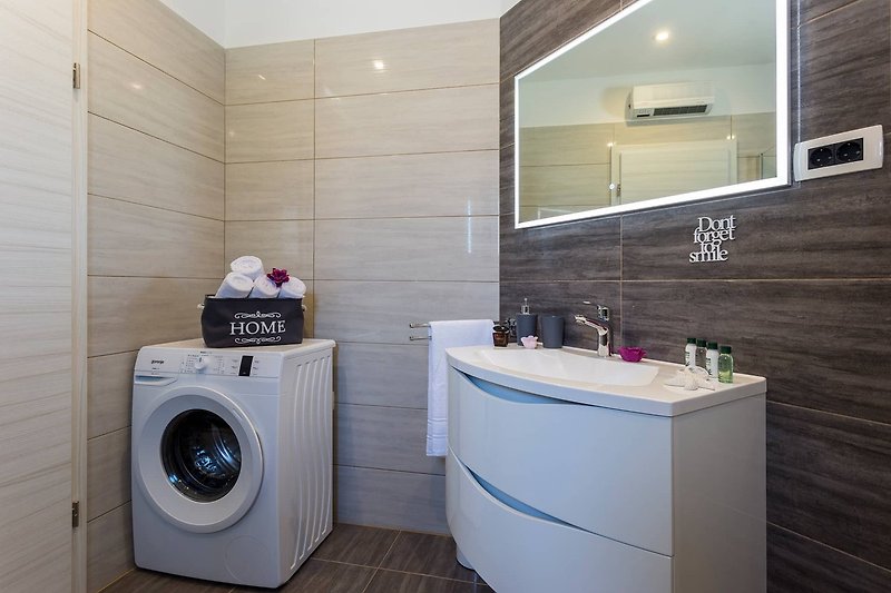 Spacious laundry room with modern appliances and sleek design.