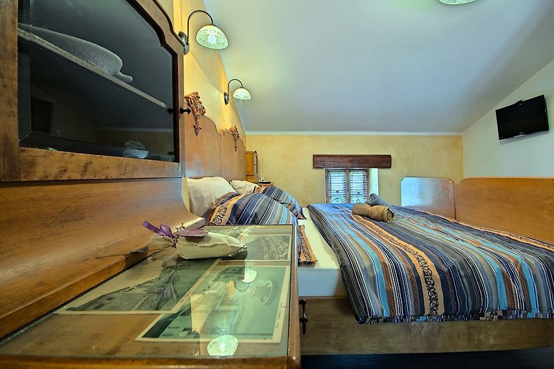 Modernes Schlafzimmer mit Holzbett und gemütlicher Bettwäsche.