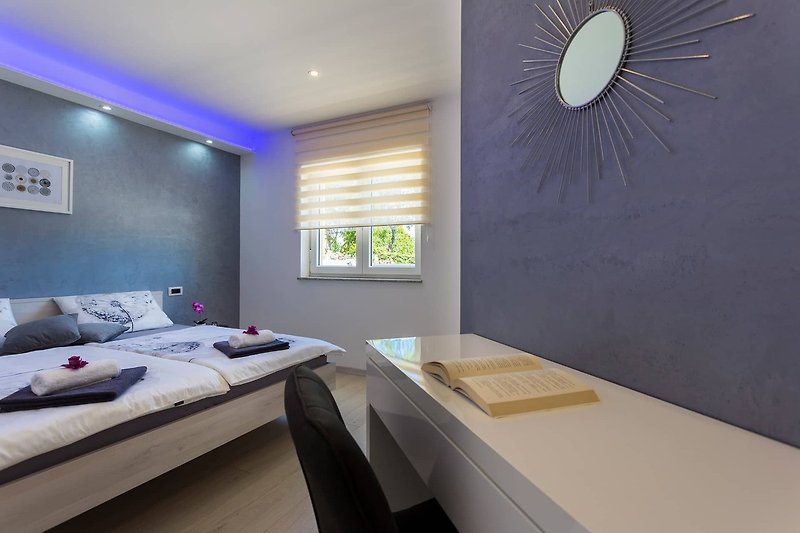 Stylish bedroom with comfortable bed and beautiful lighting.