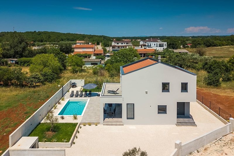 Stunning property with a beautiful landscape, swimming pool, and modern design.