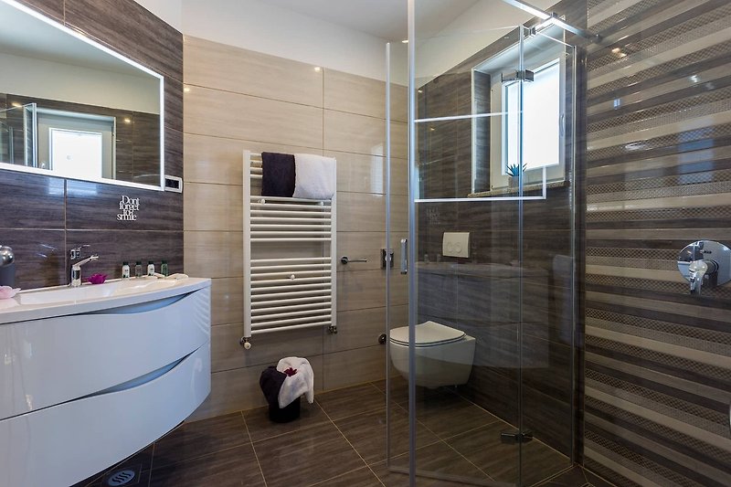 Stylish bathroom with modern fixtures and beautiful tile flooring.