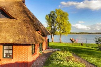 Stylish thatched house directly on the lake