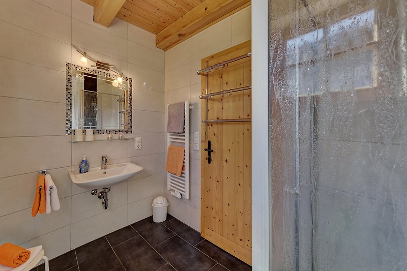 Badezimmer mit modernem Waschbecken und stilvollen Fliesen im EG