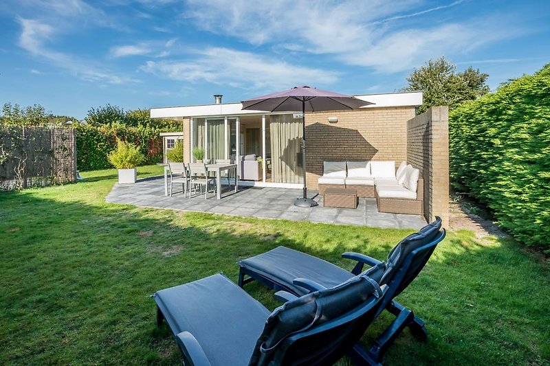Large, fenced garden with lounge area