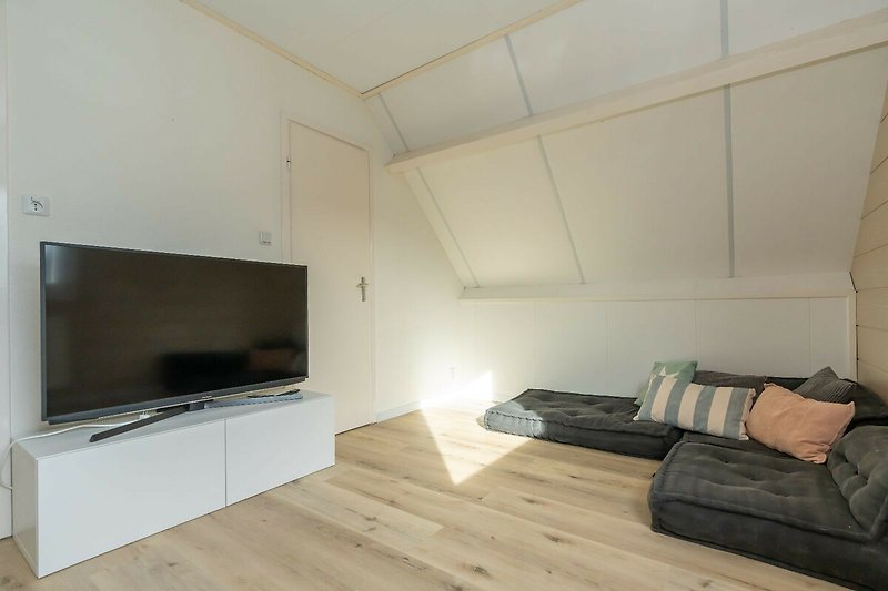 Schlafzimmer 1 mit Sitzecke und Smart TV.