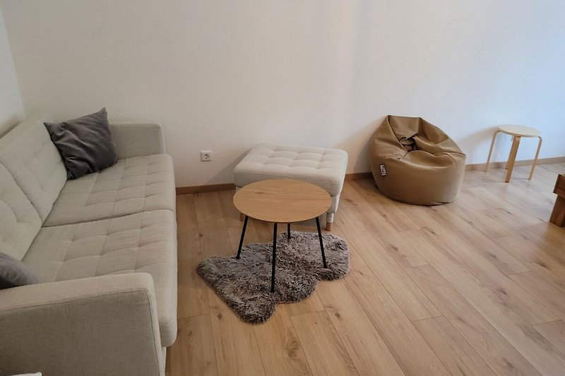 Gemütliches Wohnzimmer mit bequemer Couch und stilvollem Holzinterieur.