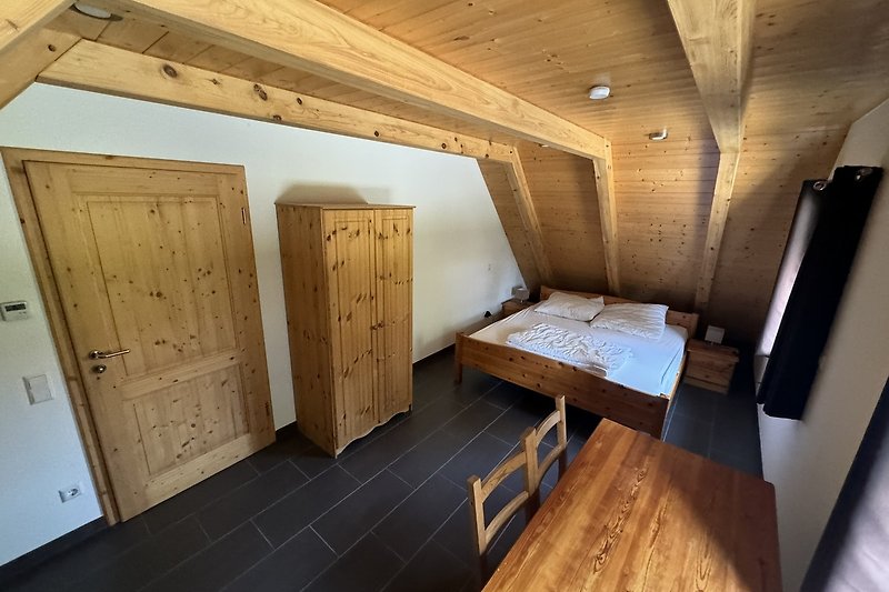 Holzdecke, Dachbalken, Holztür, rustikales Zimmer.