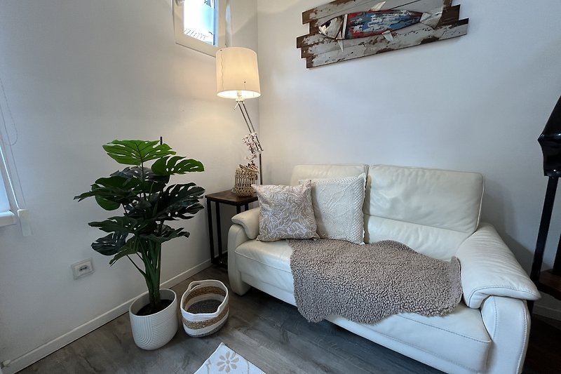 Gemütliches Wohnzimmer mit Holzmöbeln, Pflanzen und gemütlicher Beleuchtung.