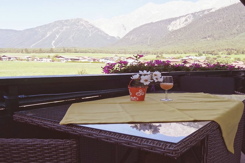 Genießen Sie die atemberaubende Aussicht auf die Berge und entspannen Sie sich auf der Terrasse.