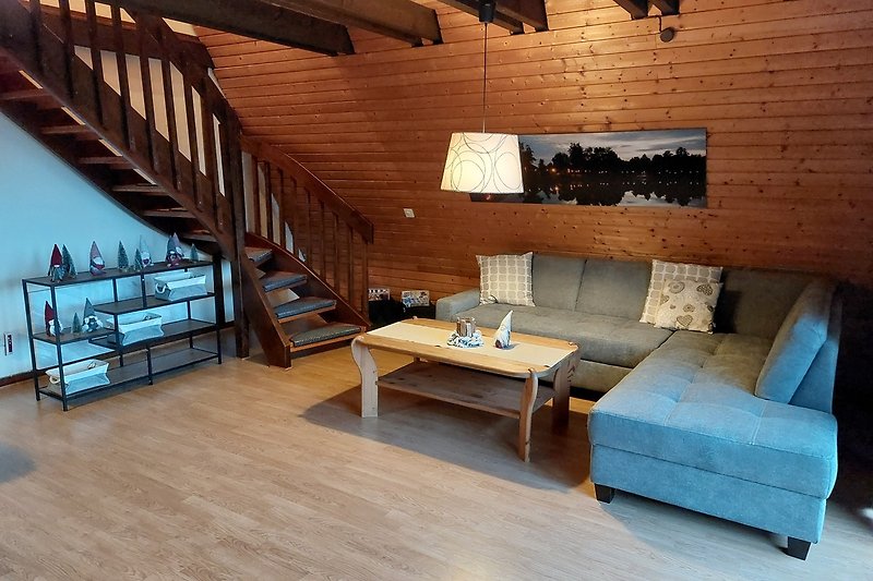 Gemütliches Wohnzimmer mit Holzmöbeln und gemütlicher Einrichtung.