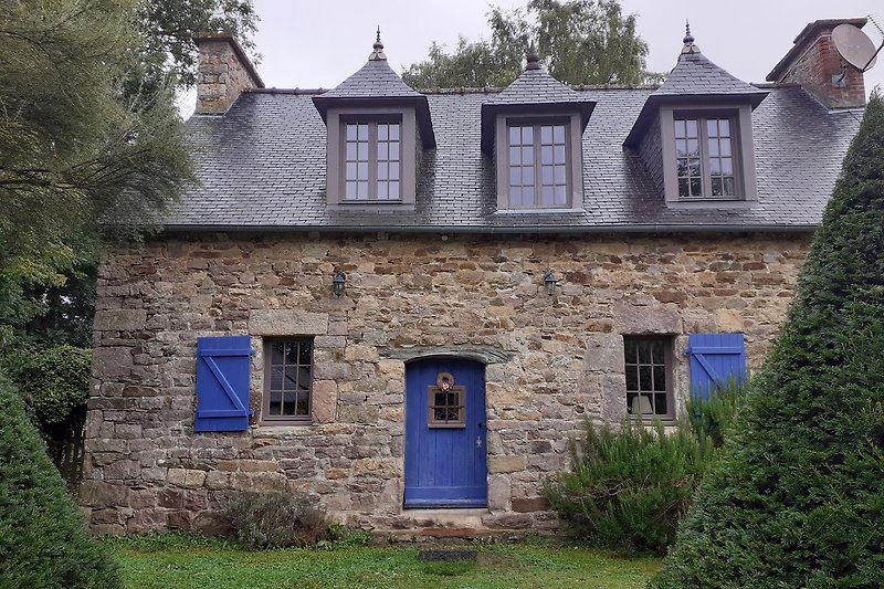 Historisches Landhaus mit Reetdach und gepflegtem Garten.