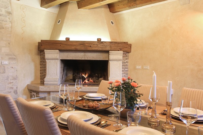 A fireplace next to the dining table.