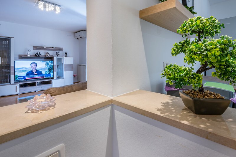 Die Dekoration mit einem Bonsai-Baum verleiht dem Raum eine grüne Note