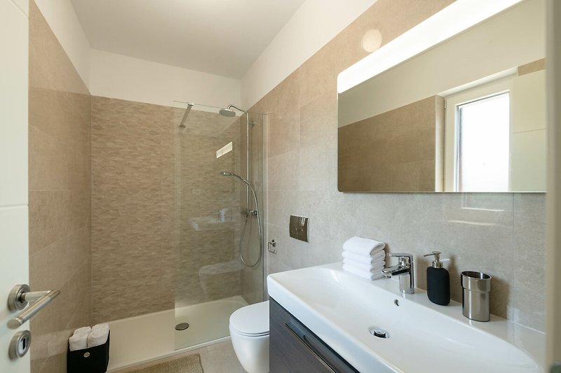 Schönes Badezimmer mit stilvoller Beleuchtung und modernem Waschbecken.