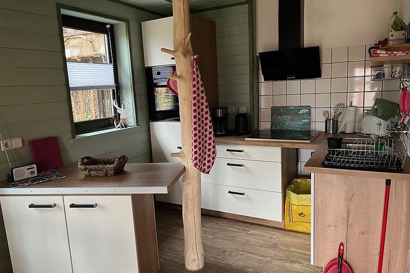 Gemütliche Küche mit Holzmöbeln und Fensterblick.