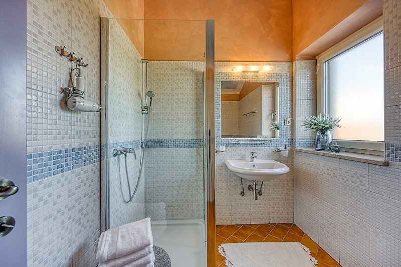Gemütliches Badezimmer mit lila Akzenten und stilvoller Armatur.