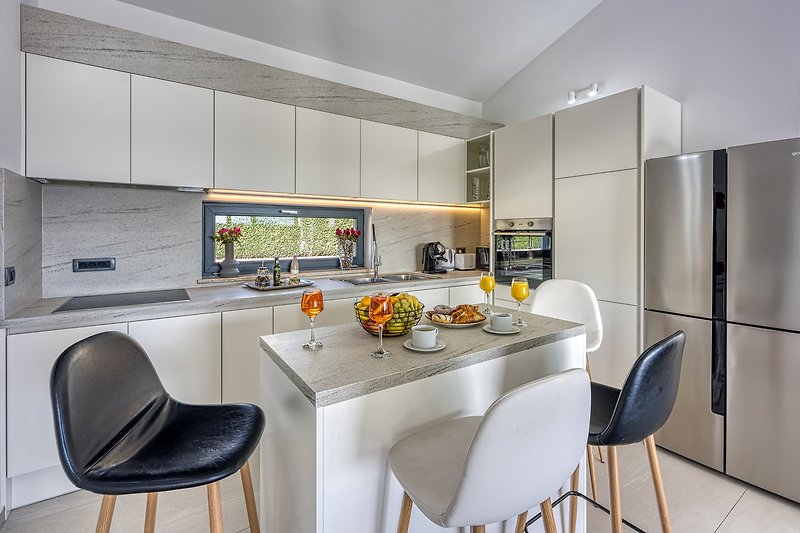 Stylish kitchen with modern appliances and elegant furniture.