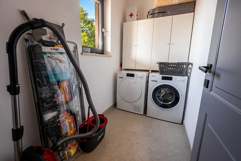 Spacious laundry room with modern appliances and plenty of storage.