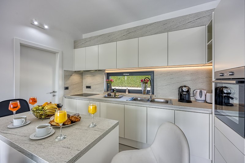 Stylish kitchen with modern appliances and elegant furniture.