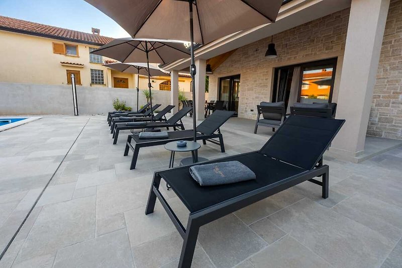 Stylish outdoor furniture on a sunny patio with a view.