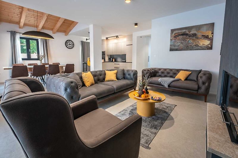 A stylish living room with a comfortable couch, wooden coffee table, and elegant decor.