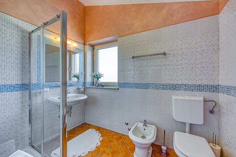 Gemütliches Badezimmer mit lila Akzenten und stilvoller Armatur.