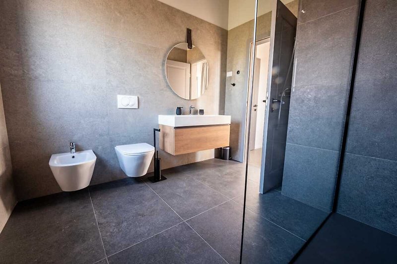 Stylish bathroom with modern fixtures and elegant tile flooring.