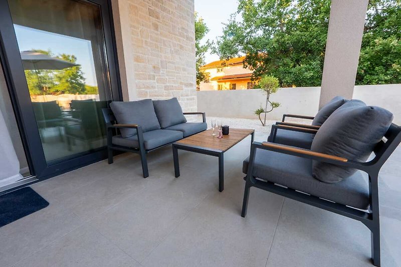 A comfortable living room with stylish furniture and a view of the outdoors.