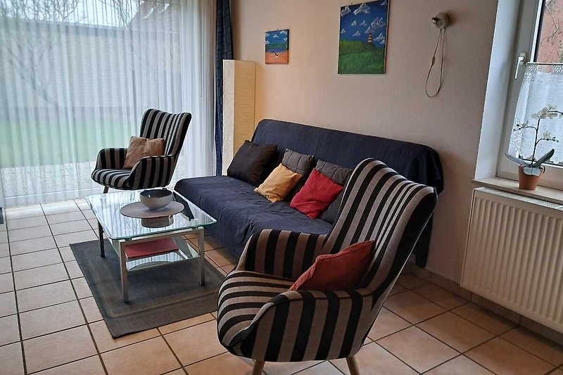 Stilvolles Wohnzimmer mit bequemer Couch, elegantem Tisch und gemütlichen Sesseln.