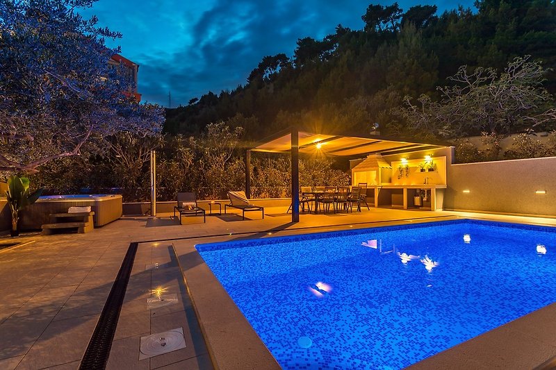 Heated swimming pool with dining area and a traditional barbecue