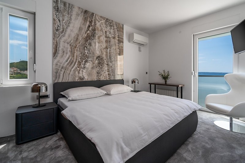 A seaview Bedroom No4 with king size bed 180cm x 200cm, a flat screen TV, air-conditioning and approach to the terrace