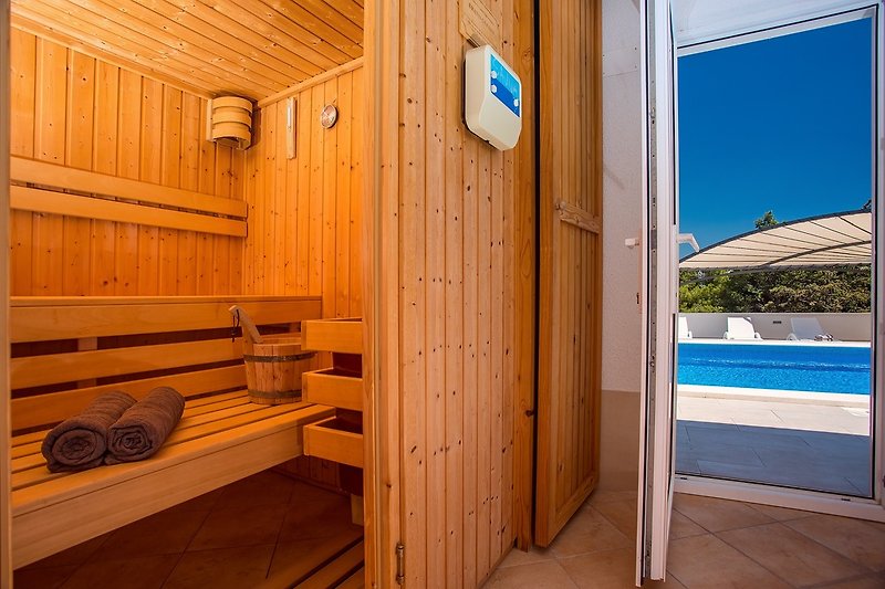 Sauna place next to pool area with shower and toilet