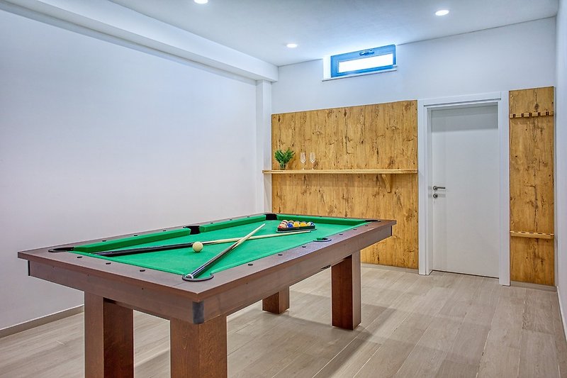 You can enjoy yourself in a room with a Billiard (a Pool table) and darts