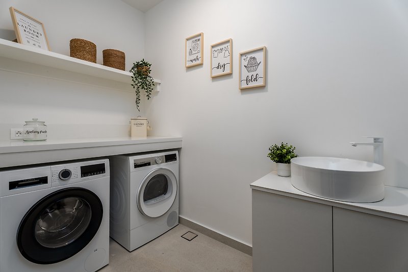 A well-lit laundry room with modern appliances and stylish decor.