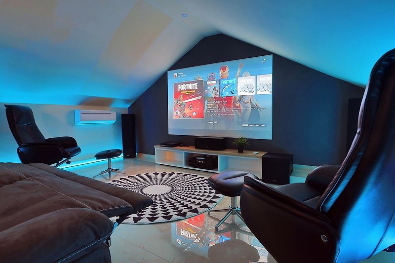a Projector, PS4, Netflix, HBO, free WiFi, A/C, and relaxing sofas