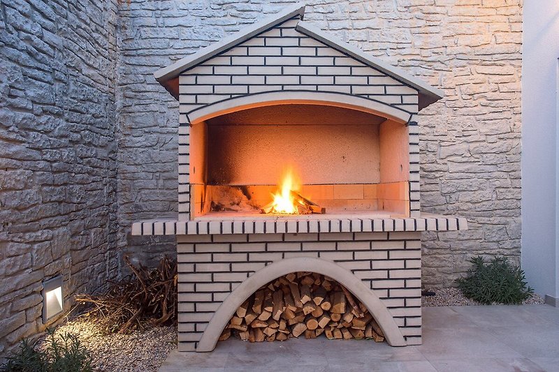 Cozy fireplace surrounded by brick and wood, perfect for a relaxing holiday.