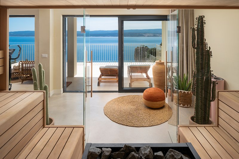 The glass doors lead to a spa area that includes a large Finnish sauna with a view of the Adriatic sea