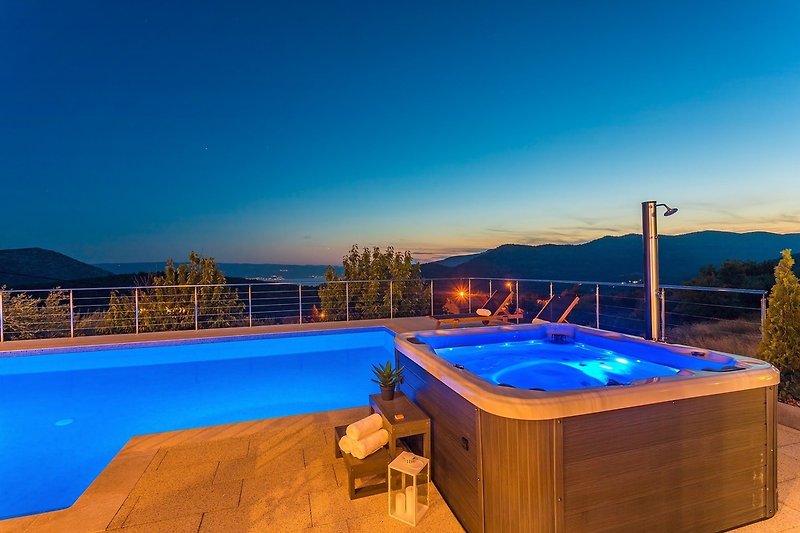 A night view on private swimming pool and Jacuzzi 