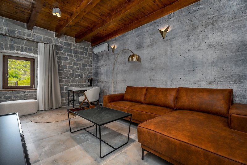 A modern and elegant interior that shows the simple beauty of a traditional Croatian stone house with a modern approach